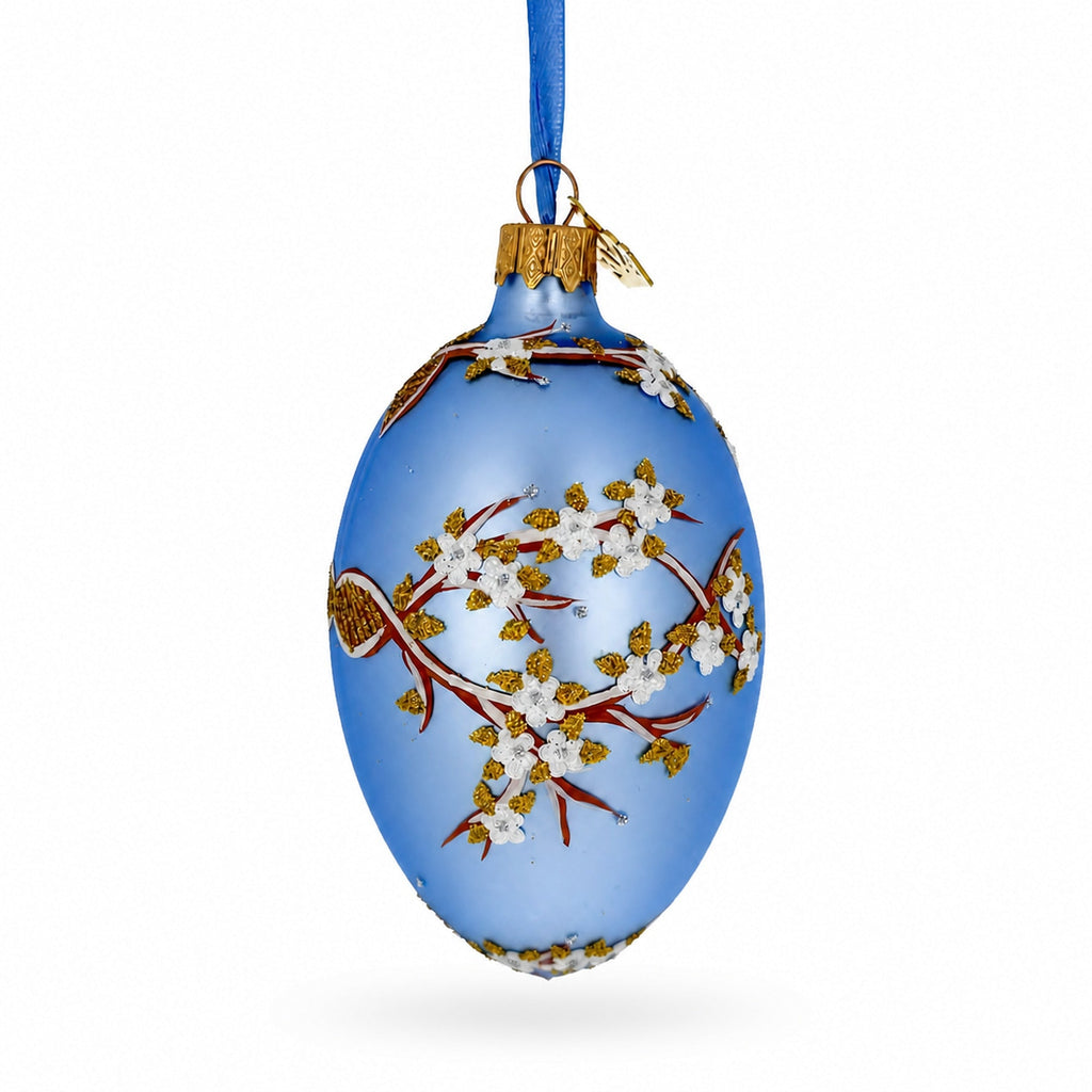 White Blossom Branch on Light Blue Glass Egg Ornament